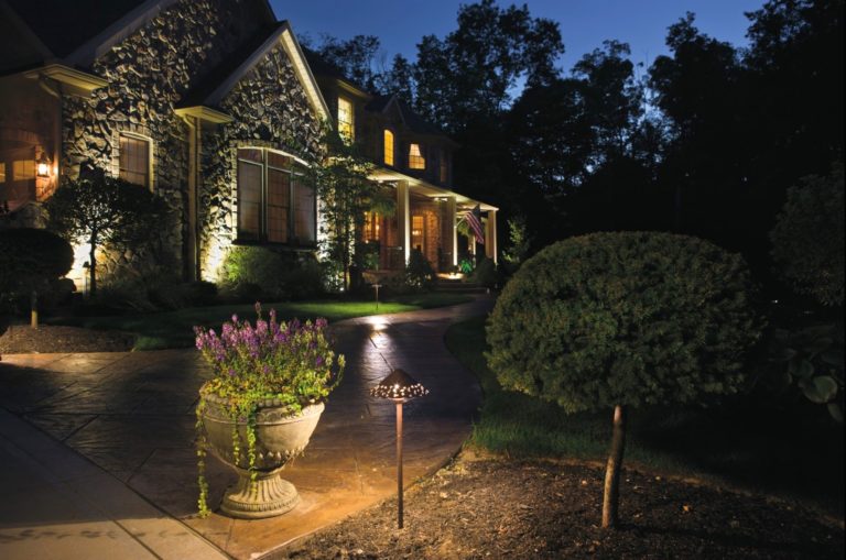 Residential outdoor lighting design on large two-story home at night - Landscape lighting Orlando