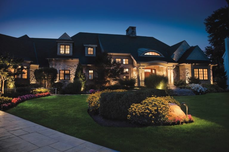 home with outdoor lighting design at night - Landscape lighting Orlando