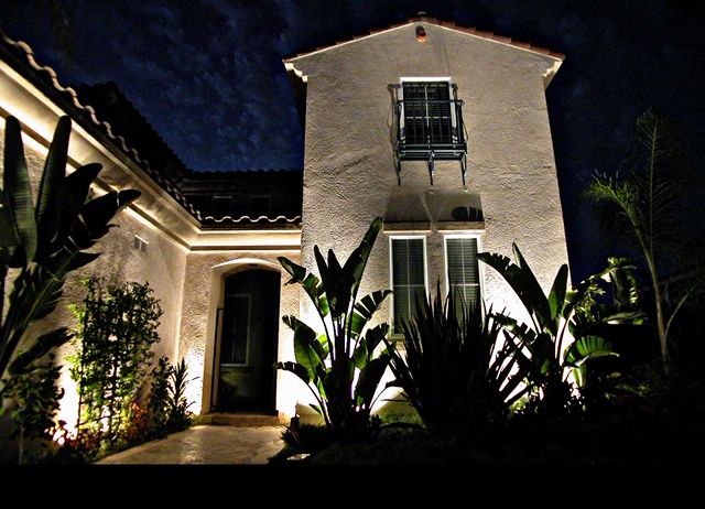 Residential landscape lighting on two-story home