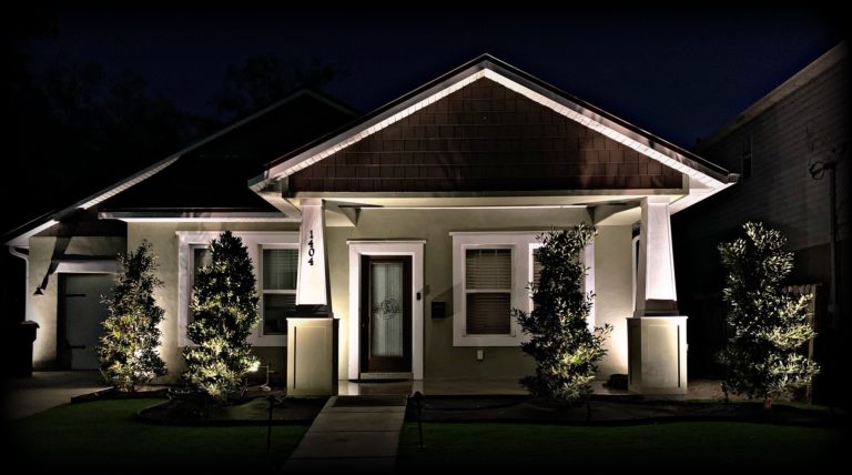 Residential landscape lighting of home at night